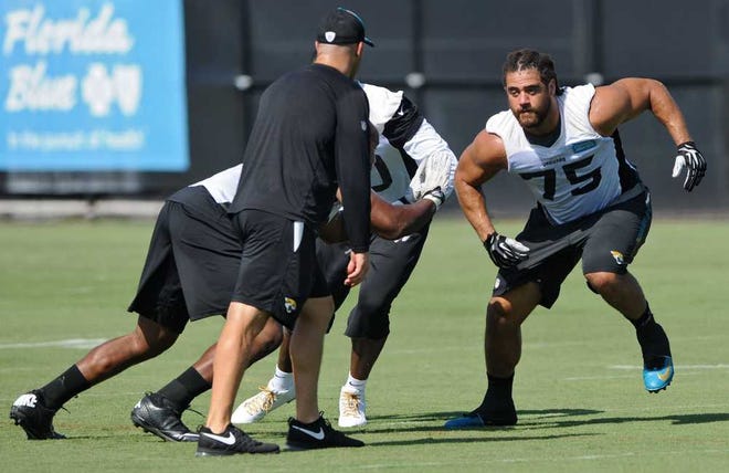 Bob.Mack@jacksonville.com Defensive lineman Jared Odrick (75) works in drills with defensive end Ikponmwosa Igbinosun (left) and defensive end Andre Branch during the second of three days of minicamp for the Jaguars on Wednesday.