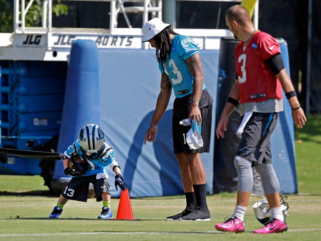 Carolina Panthers Kelvin Benjamin, center, and Derek Anderson, right, watch as Matthew McCaskill, 7, of Fort Bragg, N.C., runs a drill during minicamp on Wednesday in Charlotte, N.C. McCaskill was taking part in the practice through the Make-A-Wish Foundation.