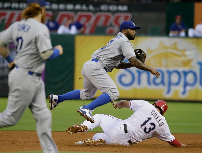 Los Angeles Dodgers second baseman Howie Kendrick (47) leaps over a sliding Texas Rangers Joey Gallo (13) for a double play during the fourth inning of a baseball game in Arlington, Texas, Tuesday, June 16, 2015. (AP Photo/LM Otero)