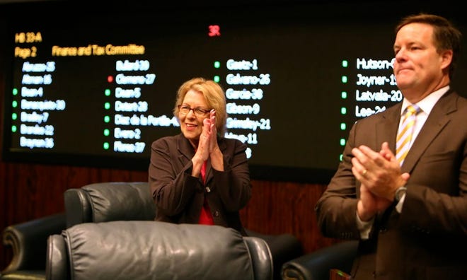 SEN. DOROTHY HUKILL, R-Port Orange, left, reacts after her tax-cut bill passed the Florida Senate on Monday in Tallahassee. Floridians will get a small cut on their cellphone bills and be able to do their back-to-school shopping tax free for 10 days under a tax cut package approved Monday by the Florida Legislature. The final budget was delivered to state legislators late Tuesday afternoon.