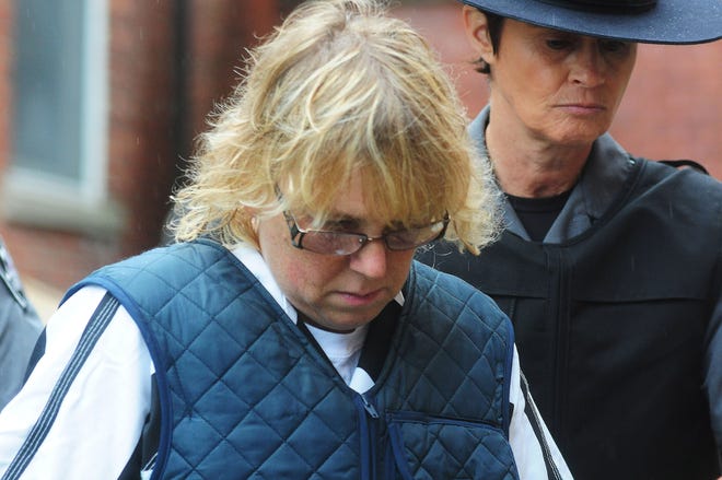 Joyce Mitchell heads into Plattsburgh City Court for her hearing, Monday. The Associated Press