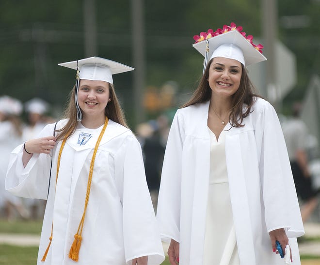 Burlington Township High School graduates Megan Jean  (left) and Alex Cunningham smile before their walk to the stadium for the graduation for the Class of 2015 on Thursday, June 18, 2015.