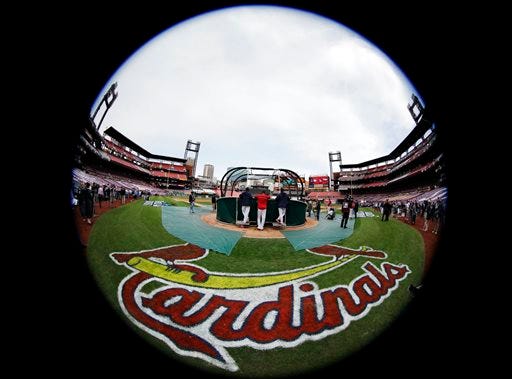 FILE - In this Oct. 28, 2015, file photo, taken with a fisheye lens, St. Louis Cardinals take batting practice before Game 5 of baseball's World Series against the Boston Red Sox in St. Louis. Federal law enforcement authorities are investigating whether the Cardinals illegally hacked into a computer database of the Houston Astros to obtain information on players, a person familiar with the situation said Tuesday, June 16, 2015, in an unusual case involving two former division rivals in Major League Baseball. (AP Photo/Matt Slocum, File)