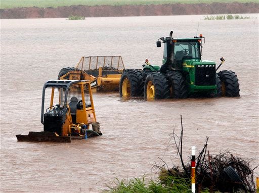 Construction equipment sits in high water from overnight rains off Interstate 35 on Thursday, June 18, 2015, in Pauls Valley, Okla. Tropical Depression Bill swamped Oklahoma and Arkansas on Thursday, pushing rivers toward record levels after the Gulf-fueled storm slowed to a crawl over the nation"™s midsection. (Steve Sisney/The Oklahoman via AP) LOCAL STATIONS OUT (KFOR, KOCO, KWTV, KOKH, KAUT OUT); LOCAL WEBSITES OUT; LOCAL PRINT OUT (EDMOND SUN OUT, OKLAHOMA GAZETTE OUT) TABLOIDS OUT