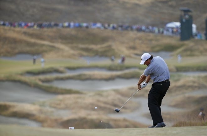 Phil Mickelson hits his tee shot on the fourth hole during the first round of the U.S. Open golf tournament at Chambers Bay on Thursday. MATT YORK/THE ASSOCIATED PRESS