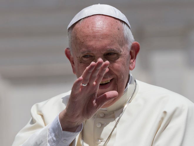 Pope Francis waves as he leaves at the end of his weekly general audience, in St. Peter's Square at the Vatican, Wednesday, June 17, 2015.