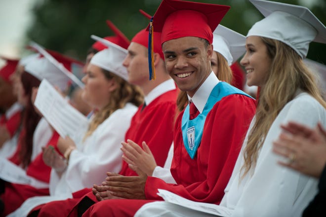 A graduate smiles during the commencement ceremony for the class of 2015 at Rancocas Valley High School in Mount Holly Friday evening, June 19, 2015.