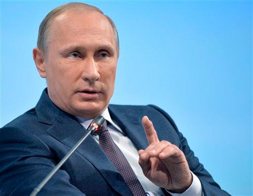 Russian President Vladimir Putin gestures as he speaks during a plenary session of an economic forum in St. Petersburg, Russia, Friday, June 19, 2015. Russia isn't seeking dominance or superpower status, but wants its interests to be respected by the United States and its Western allies, Putin said Friday as he sought to assuage investors spooked by Russia's recession and a showdown over Ukraine. (Alexei Druzhinin/RIA-Novosti, Kremlin Pool Photo via AP)