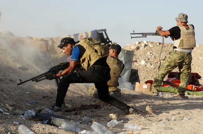 Associated Press Iraqi security forces defend their positions against an Islamic State group attack in Husaybah, near Ramadi, Iraq on June 15. The Islamic State group still holds about a third of Iraq and Syria, including Iraq's second-largest city, Mosul.