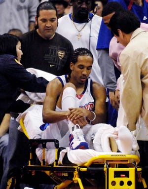 In this Feb. 26, 2007 file photo, Los Angeles Clippers' Shaun Livingston sits on a stretcher after injuring his knee during the first quarter of an NBA basketball game against the Charlotte Bobcats in Los Angeles. Livingston was down and out after shredding his knee when he landed after a layup attempt in a Feb. 26, 2007, game. He had gone from being the No. 4 overall pick straight out of a Peoria, Ill., high school to contributing to a rare Los Angeles Clippers playoff run to suddenly needing to learn to walk again. (AP Photo/Chris Pizzello, File)