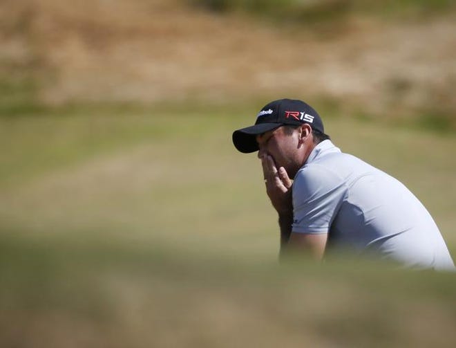 Jason Day, of Australia, reacts after missing a putt on the ninth hole during the third round of the U.S. Open golf tournament at Chambers Bay on Saturday, June 20, 2015 in University Place, Wash.