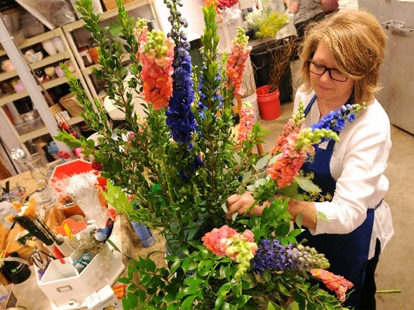 New Owner Robin Cox puts together an arrangement at Verzaal's Florist off Shipyard Blvd Tuesday June 9, 2015. The florist shop that has been around since 1931 has recently come under new ownership.