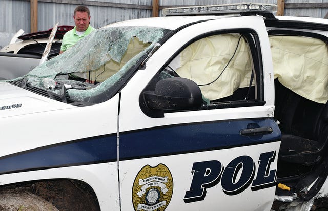 CHAD HUNTER TIMES RECORD / Greenwood Police Chief Will Dawson surveys damage to a police vehicle Wednesday afternoon, June 17, 2015. Police say a Jessica Sterling, 23, stole the SUV then wrecked it Tuesday night.