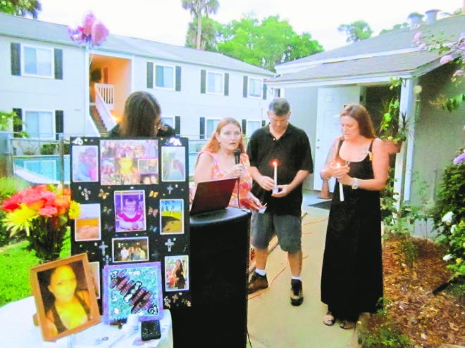 Shirley Gabbard, apartment manager, center, speaks during Sunday night’s vigil, along with her daughter,
Kelly Lowe, right, a close friend of Brandy Johnson.