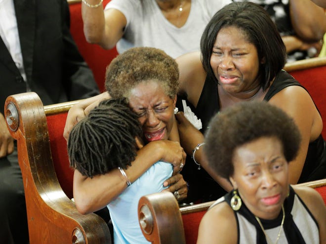 Parishioners pray and weep during services at the Emanuel A.M.E. Church Sunday, in Charleston, S.C., four days after a mass shooting that claimed the lives of it's pastor and eight others. AP Photo/David Goldman, Pool