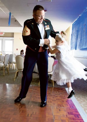 Master Gunnery Sgt. Christopher Jordan dances with his little girl, Sophia, 6, at the Daddy-Daughter Dance at New River Officers' Club on Saturday.
