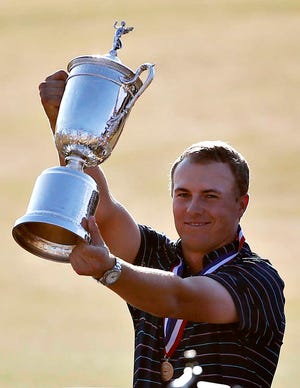 Jordan Spieth holds up the trophy after winning the U.S. Open golf tournament at Chambers Bay on Sunday, June 21, 2015 in University Place, Wash. (AP Photo/Lenny Ignelzi)