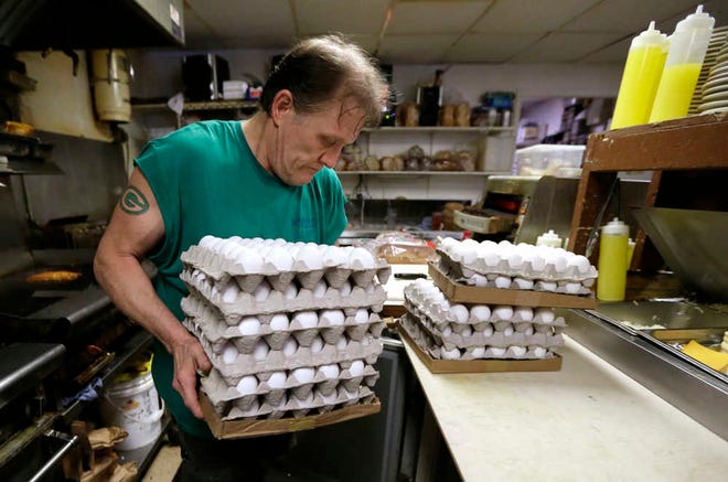 Nick Wells puts eggs in a cooler at the Waveland Cafe, Friday, June 19, 2015, in Des Moines, Iowa. Restaurants are struggling to deal with higher egg prices and an inability to get enough eggs and egg products in the midst of a shortage brought about by a bird flu virus that wiped out millions of chickens on commercial farms this spring.(AP Photo/Charlie Neibergall)