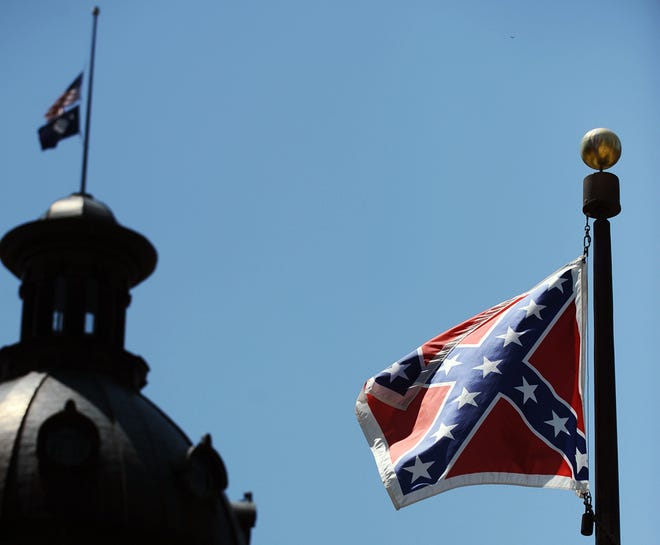 The Confederate flag flies near the South Carolina Statehouse on Friday in Columbia, S.C. Tensions over the Confederate flag flying in the shadow of South Carolina's Capitol rose this week in the wake of the killings of nine people at a black church in Charleston, S.C.