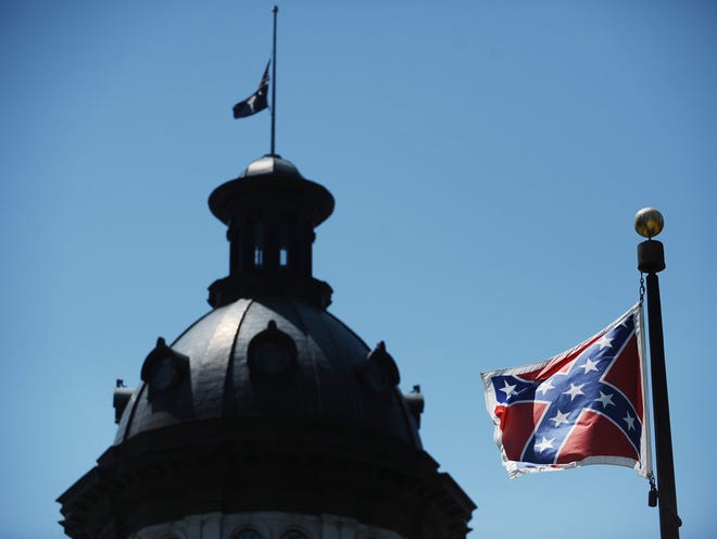 In this June 19, 2015, photo, a Confederate flag flies near the South Carolina Statehouse in Columbia, S.C.