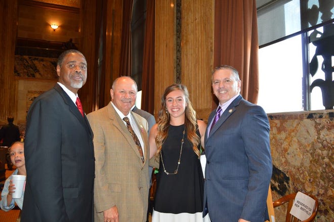 From left right, Representatives Ed Price and Johnny Berthelot honor Kara Gremillion, along with Representative Clay Schexnayder.
