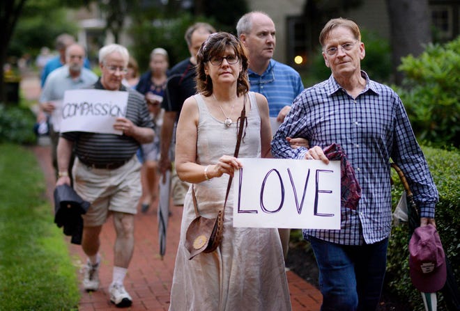 Barbara Simmons (center) of the Bucks County Peace Center walks with her husband, Steve Nolan, during an Interfaith Prayer Walk for peace, racial justice and reconciliation Tuesday, June 23, 2015 in Langhorne.