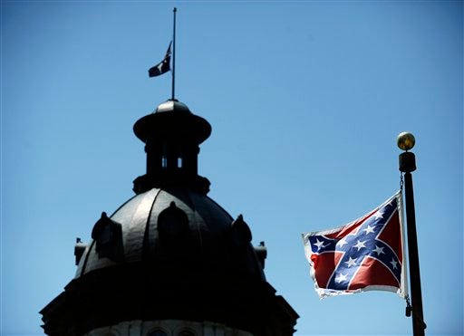 In this June 19, 2015, photo, a Confederate flag flies near the South Carolina Statehouse in Columbia, S.C. Whether South Carolina should continue to fly the Confederate flag on its statehouse grounds is the latest in a series of issues to arise this summer challenging the GOP's effort to build the young and diverse coalition of voters it likely needs to win the White House. (AP Photo/Rainier Ehrhardt)