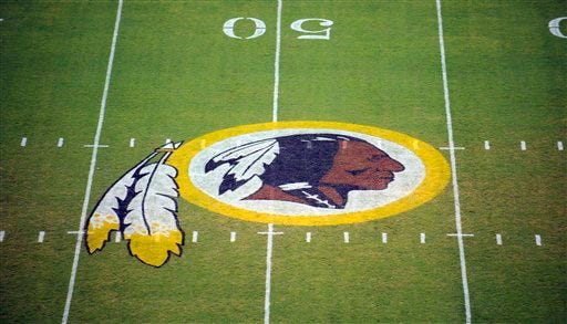 FILE - In this Aug. 28, 2009 file photo, the Washington Redskins logo is seen on the field before the start of a preseason NFL football game in Landover, Md. A judge is hearing arguments from the Washington Redskins on June 23, 2015, that canceling the team's trademarks would infringe its free-speech rights. The hearing is scheduled on a lawsuit to overturn a decision by the Trademark Trial and Appeal Board to cancel the trademark on the grounds that it may be offensive to Native Americans. (AP Photo/Nick Wass, File)