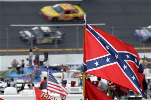FILE - In this Oct. 7, 2007, file photo, a Confederate flags fly in the infield as cars come out of turn one during a NASCAR auto race at Talladega Superspeedway in Talladega, Ala. NASCAR is backing South Carolina Gov. Nikki Haley's call to remove the Confederate flag from the South Carolina Statehouse grounds in the wake of a massacre at a Charleston church, it said in a statement Tuesday, June 23, 2015. Though NASCAR bars the use of the flag in any official capacity, many fans fly the flag at their races. (AP Photo/Rob Carr, File)