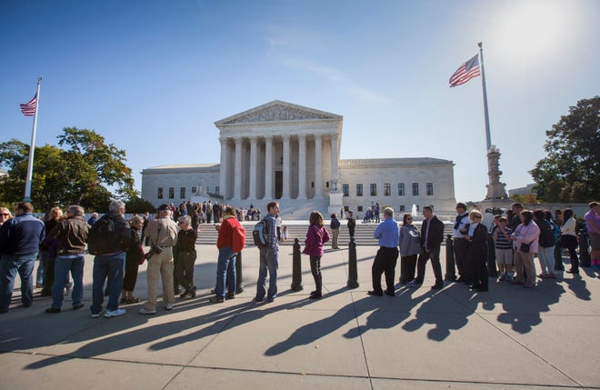 In this Oct. 16, 2014, file photo, people wait to enter the Supreme Court in Washington. Only two years ago, the Supreme Court struck down part of the federal anti-gay marriage law that denied a range of government benefits to legally married same-sex couples. The decision did not address the validity of state marriage bans, but courts across the country, with few exceptions, said its logic compelled them to invalidate state laws that prohibited gay and lesbian couples from marrying. (AP Photo/J. Scott Applewhite, File )