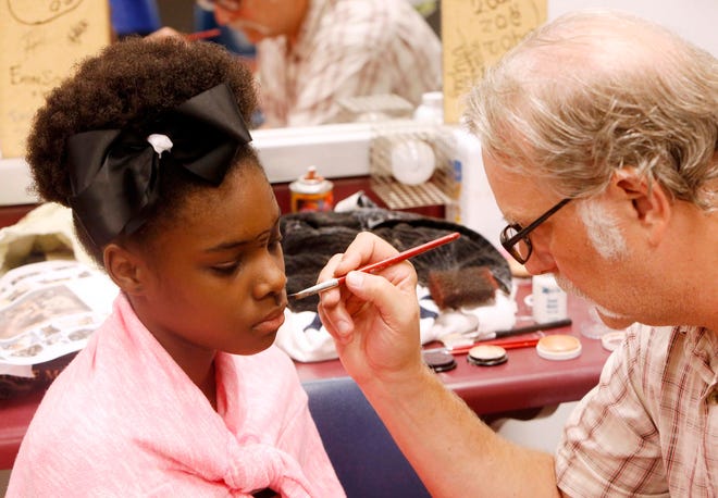 Jeff Wilson, an acting and makeup instructor, applies makeup to McKenzie Atkins', 12, face during Theatre Camp 2015 hosted at Shelton State Community College Tuesday, June 23, 2015.