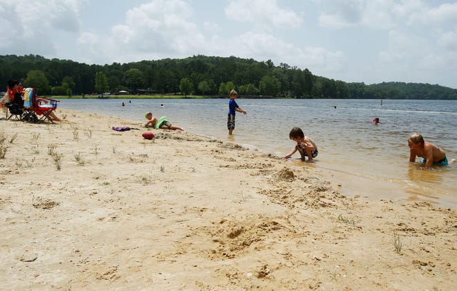 Children play on the beach and swim in the water at Lake Lurleen in Coker on Monday, June 30, 2014.