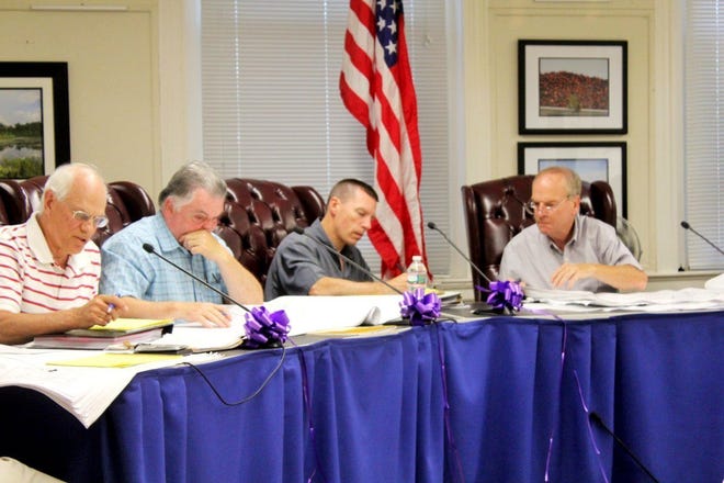 From left, Planning Board members Robert Reed and John Cronan, interim Town Planner David Pichette and Chairman George Barrett review plans.

Wicked Local Photo/Chris Shott