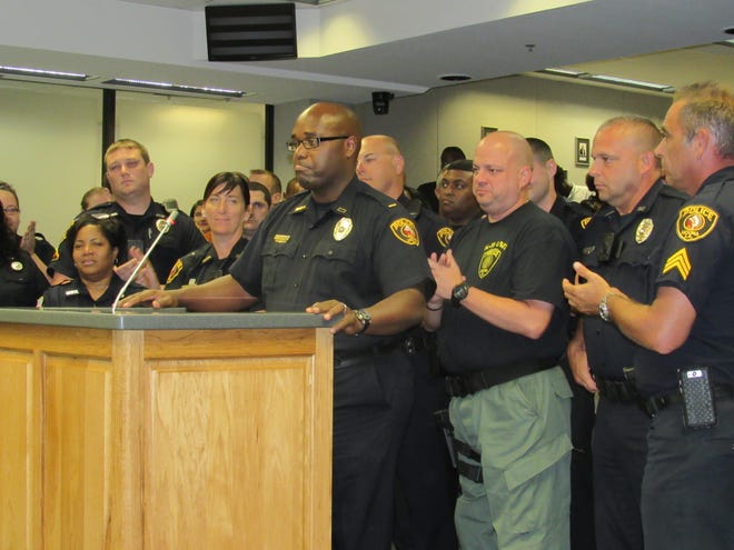 Newly appointed Houma Police Chief Dana Coleman accepts the position during Wednesday’s Parish Council meeting with fellow officers standing behind him in support.