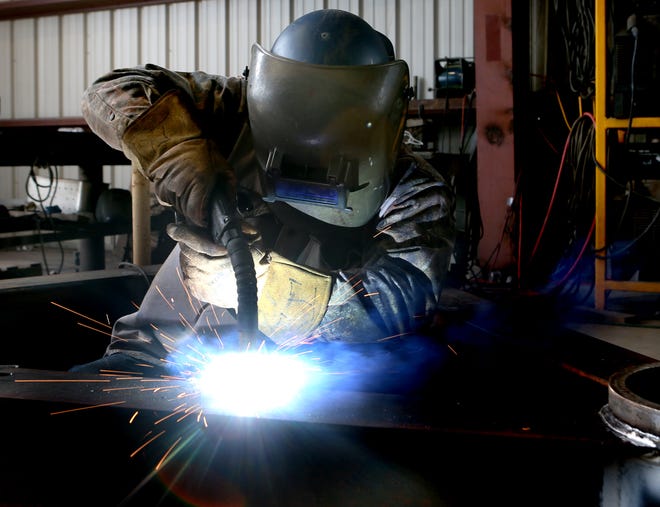 Jesse Guidry welds a piece of sub-sea equipment Wednesday at Cajun Cutters in Houma.