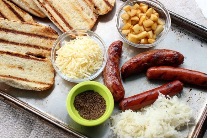 BRATWURST GRINDERS WITH APPLE, cheddar and sauerkraut goes a bit beyond the ordinary for your July Fourth holiday.