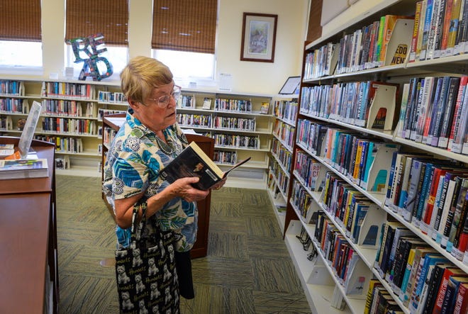 Wanda Bessa of Osprey picks out a book at the Osprey Public Library at Historic Spanish Point. Bessa says she loves the location and the hometown feel.