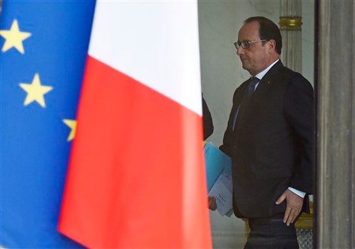 French President Francois Hollande walks through the lobby of the Elysee Palace after the weekly cabinet, Wednesday, June 24, 2015 in Paris, France. France summoned the U.S. ambassador to the Foreign Ministry on Wednesday following revelations by WikiLeaks that the U.S. National Security Agency eavesdropped on the past three French presidents. (AP Photo/Kamil Zihnioglu)