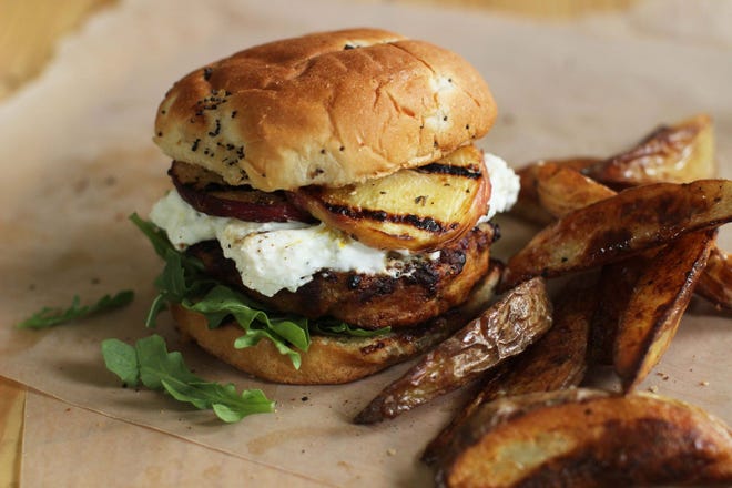 Turkey burgers with goat cheese and grilled peaches. THE ASSOCIATED PRESS