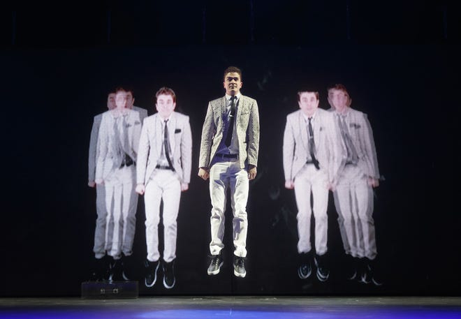 Adam Trent, whose stage name is The Futurist, performs in "The Illusionists," in New York. The Associated Press