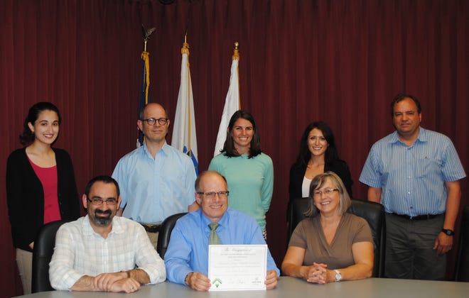 Suzanne Snyder and Christine Andrews of the Next Step Living outreach team and members of the Chelmsford Energy Conservation Committee attend the Chelmsford Saves press event. Pictured, from left, back row, Mashail Arif, Simon Dukes, Suzanne Snyder, Christine Andrews and Dave Sperry; and front row, George Kaliviotis, Gary Krauch and Kathleen Canavan. Courtesy Photo