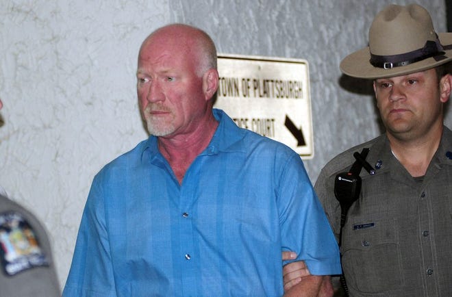 A New York State Police officer escorts suspended Clinton Correctional Facility guard Gene Palmer, left, from Plattsburgh Town Court in Plattsburgh, N.Y., Wednesday, June 24, 2015. Palmer is believed to have delivered tools inside frozen meat to two Clinton Correctional Facility inmates before they escaped on June 6. He faces charges including promoting prison contraband and tampering with physical evidence, state police said. (Rob Fountain/The Press-Republican via AP)