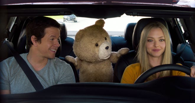 From left, Mark Wahlberg, the character Ted, voiced by Seth MacFarlane, and Amanda Seyfried appear in a scene from “Ted 2.”