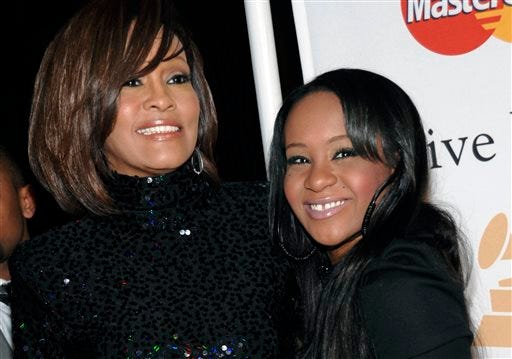 FILE - In this Feb. 12, 2011, file photo, singer Whitney Houston, left, and daughter Bobbi Kristina Brown arrive at an event in Beverly Hills, Calif. Brown is moving to hospice care after months of receiving medical care. Pat Houston says in a statement Wednesday, June 24, 2015, that Whitney Houston"™s daughter"™s "œcondition has continued to deteriorate. Brown was found face-down and unresponsive in a bathtub of her Georgia home earlier this year. She underwent surgery to replace her breathing tube with a tracheostomy tube in February. (AP Photo/Dan Steinberg, File)