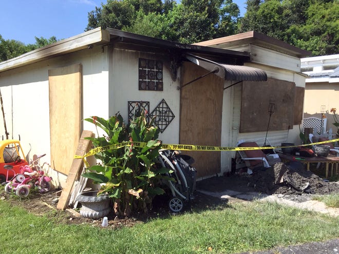 A trailer damaged by a fire is cordoned off at Lake John's Motel Efficiency on West Colonial Drive in Oakland, Fla., Wednesday, June 17, 2015. Two young boys ran into the burning trailer Tuesday and saved a toddler and a baby from a fire.