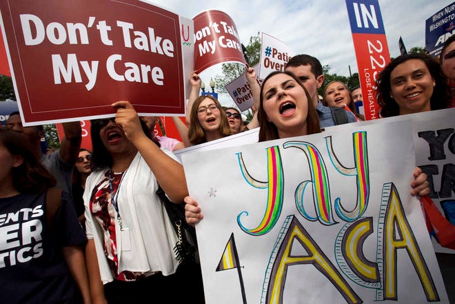 Jessica Ellis, right, holds a sign that says "yay 4 ACA," as she and other supporters of the Affordable Care Act react with cheers as the opinion for health care is reported outside of the Supreme Court in Washington, Thursday June 25, 2015, in Washington. (AP Photo/Jacquelyn Martin)