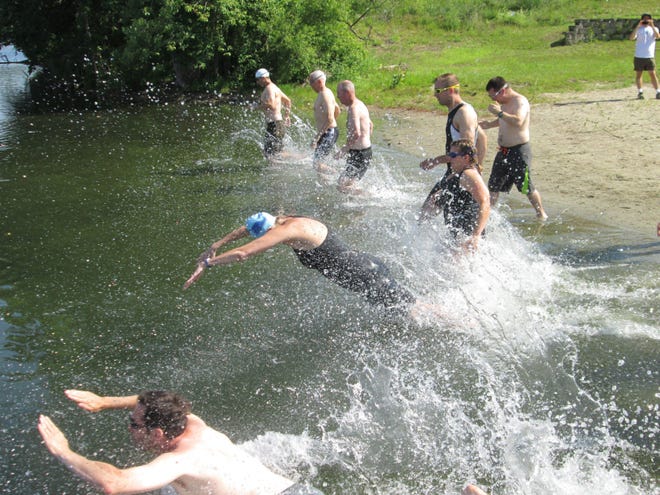 Swimmers dive into Dug Pond at the start of last year’s annual Family Mini-Triathlon. This year’s event will take place Sunday.

WICKED LOCAL PHOTO/MAUREEN SULLIVAN