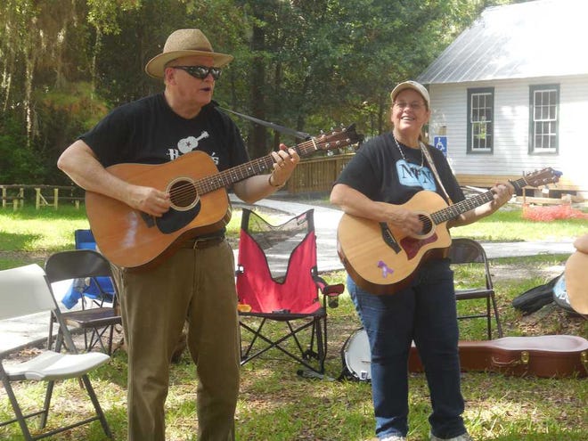 North Florida Folk Network Member Pat Plumlee (left), a retired professor from the University of North Florida, plays with fellow NFFN Member Cindy Bear. Plumlee has been leading the monthly jam sessions since February.