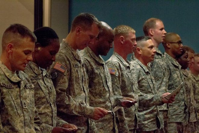Members of the North Carolina National Guard's 621st Survey and Design Team join in song for the 'Army Song' during their demobilization ceremony after a year-long deployment on June 26, 2015.