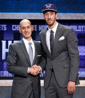 NBA Commissioner Adam Silver poses for a photo with Frank Kaminsky after Kaminsky was selected ninth overall by the Charlotte Hornets during the NBA basketball draft, Thursday, June 25, 2015, in New York. (AP Photo/Kathy Willens)